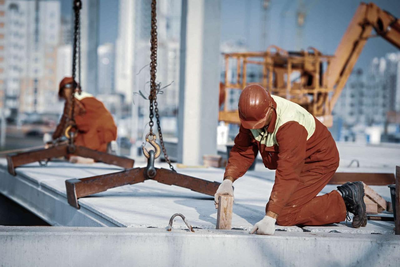 builder worker installing concrete slab